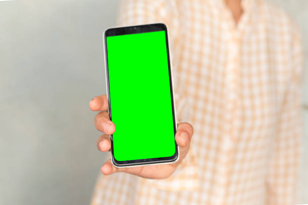 istock Hand Presenting Smartphone with Green Screen Mockup 2247905119