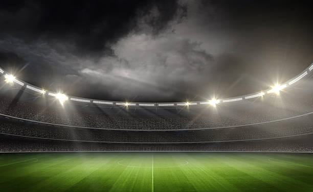 istock Dramatic Night at Stadium with Illuminated Football Field and Stormy Sky, 3d rendering 2247906716