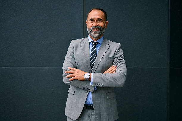 istock Mature businessman with beard standing crossing arms 2247908989
