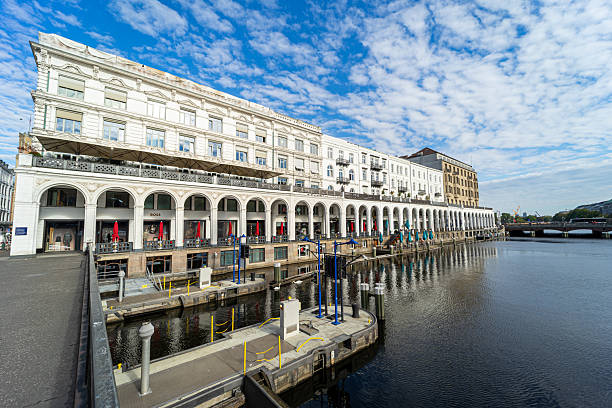 Germany, Hamburg, Binnenalster, September 30, 2025 - Hamburg Alster Arcades on the Inner Alster agierst cloudy sky