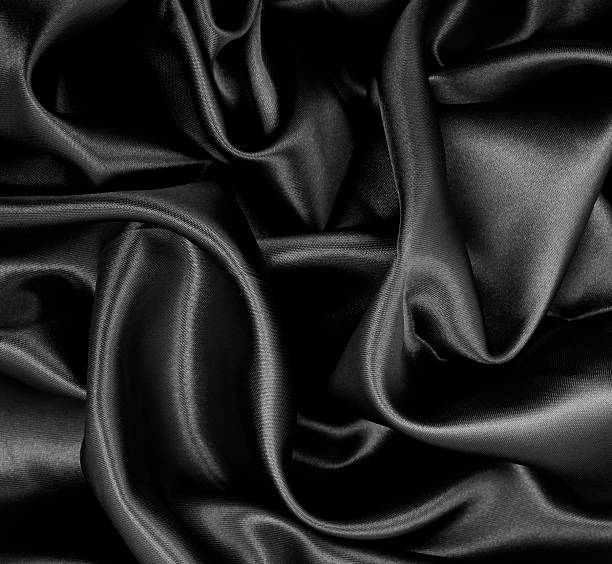 istock Smooth elegant black silk or satin texture as abstract background. Luxurious background design 2247913551