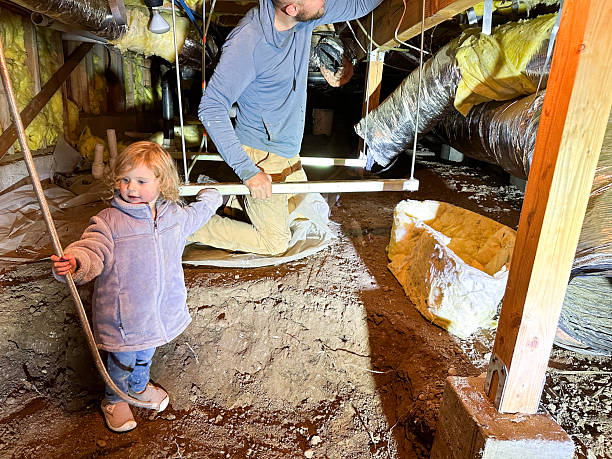 istock Toddler helping her dad work under their house while fixing a furnace 2247916028