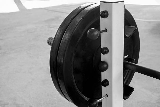 Sports bar is fixed in the weight trainer. Doing sports. Healthy lifestyle. Close-up. Selective focus. Copy space.