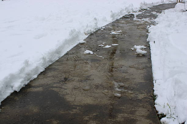 istock Snow-covered pathway with clear edges after snowfall in winter season 2247920928
