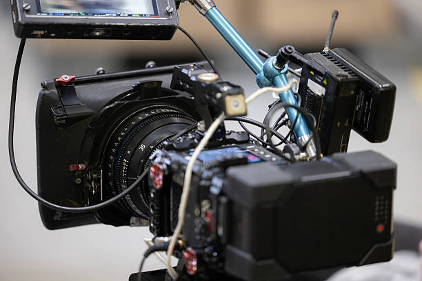 istock A professional digital cinema camera rig with a compact prime 35mm lens, a large v-mount battery. This behind-the-scenes view shows the matte box, monitor, and wireless transmitter used for filmmaking 2247922804