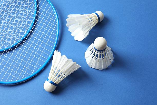 istock Badminton rackets and white badminton shuttlecocks on color background 2247924316