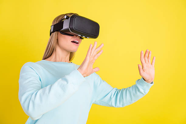 istock Photo of adorable pretty woman dressed blue pullover playing 3d game empty space isolated yellow color background 2247924568