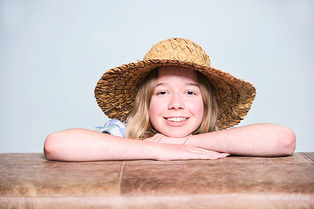 13-year-old girl blonde girl wearing a straw hat