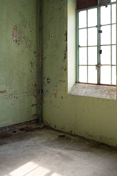 istock Light Through Grime — Sunlit Corner of Abandoned Room 2247928415