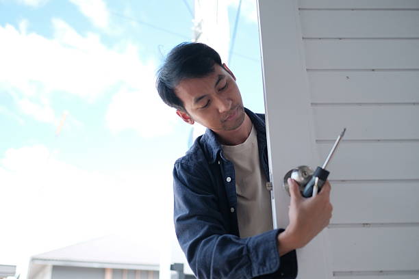 istock A man is fixing a door with a screwdriver 2247928506