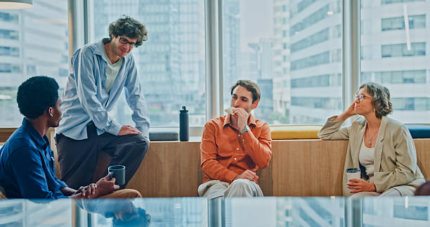 istock Diverse business team enjoying casual coffee break conversation talking and laughing together in modern office. Sustainable business and finance concept. 2247928757