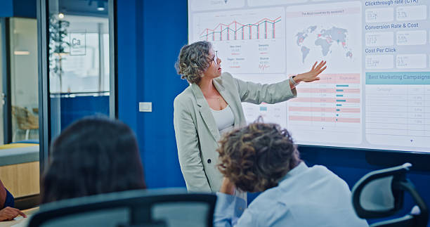 istock Diverse business team presents company data and performance charts meeting discussing strategy planning investment marketing strategies in modern office. Sustainable business and finance concept. 2247928779