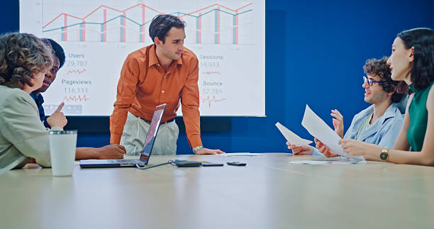 istock Diverse business team presents company data and performance charts meeting discussing strategy planning investment marketing strategies in modern office. Sustainable business and finance concept. 2247928780