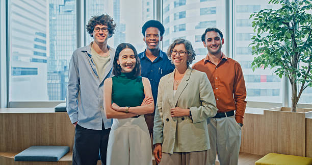 istock Diverse business team smiling looking at camera, representing teamwork, leadership, and success in modern office. Sustainable business and finance concept. 2247928843
