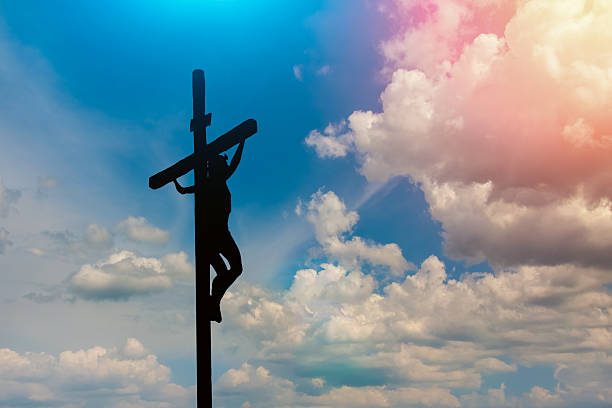 istock Jesus hanging on a large wooden cross 2247930792
