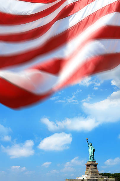 istock Statue of Liberty with American flag 2247932219