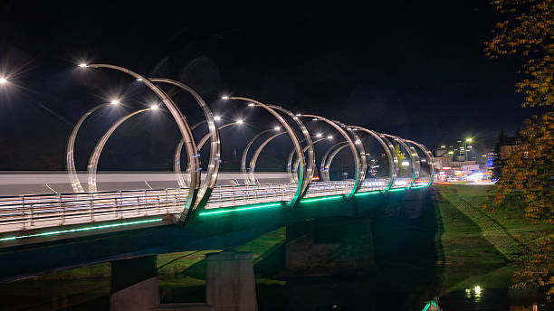 istock autumn landscape with colorful bridge lighting, evening twilight, beautiful, blurred light objects 2247932609