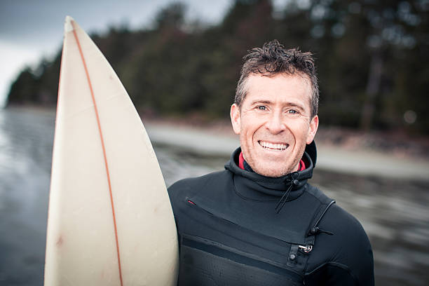 istock Portrait of surfer on beach at sunset 2247934686