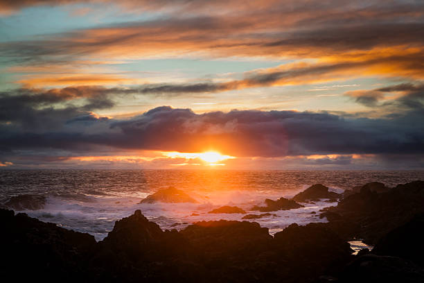 Waves crash on rocky coastline at sunset, Chesterman Beach, Pacific Rim National Park, Tofino, Vancouver Island, B.C.