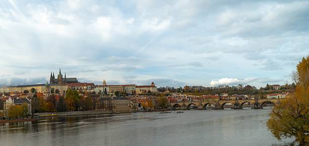 Colorful, autumn panorama of Prague from the river side, in daylight, with the Royal Hill (Hradcany)
