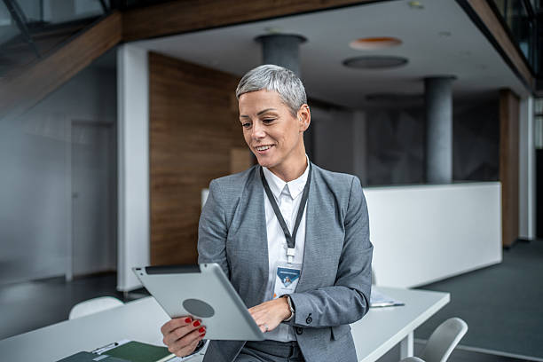istock Businesswoman smiling using digital tablet in office 2247937094