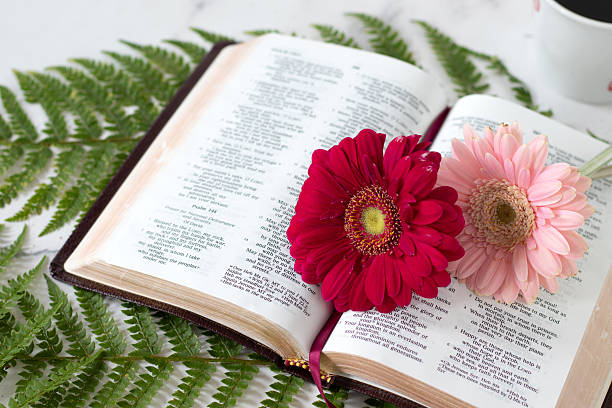 istock Open holy bible book with flowers and coffee cup 2247940658
