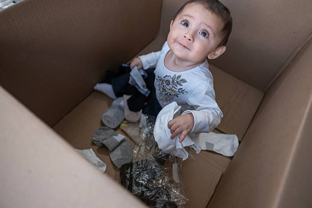 istock baby entertained playing inside a cardboard box 2247944460