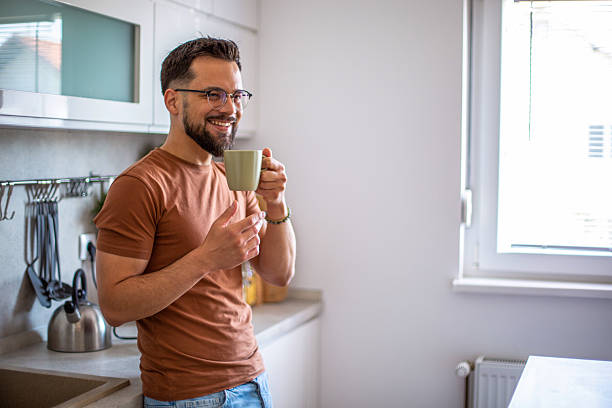 istock Happy man enjoying coffee in bright kitchen morning 2247951994