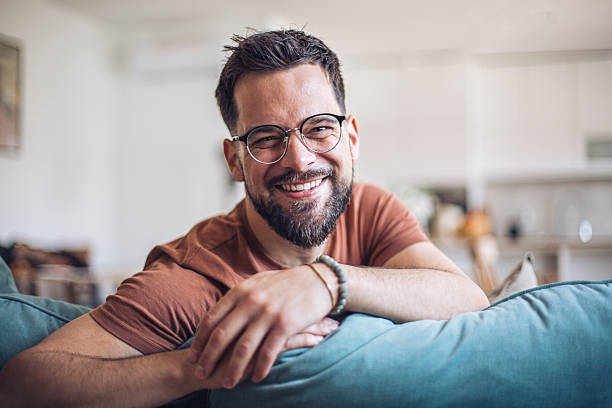 istock Relaxing man smiling on sofa at home 2247952890