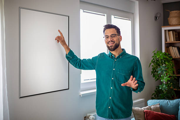 istock Young adult man pointing blank frame during presentation 2247953989