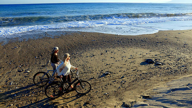 Young couple during a bike ride on the coastline