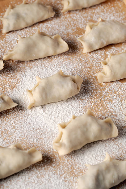 istock Raw polish dumplings on a dusted tray 2247955486