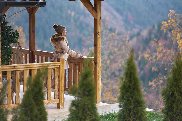 istock Woman with knitted hat admiring mountain nature view 2247959670