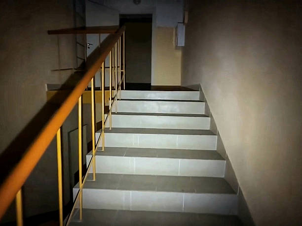 Outdoor metal staircase on red brick building.