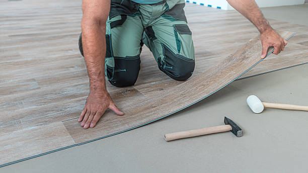 istock Floating floor work. The worker inserts the board of vinyl plank to the click system of Floating floor. 2247965351