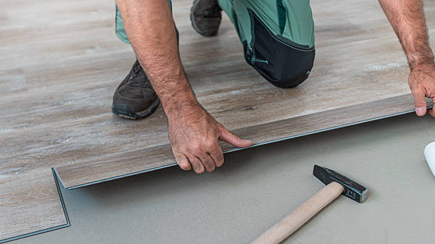 istock Floating floor work. The worker inserts the board of vinyl plank to the click system of Floating floor. 2247965461