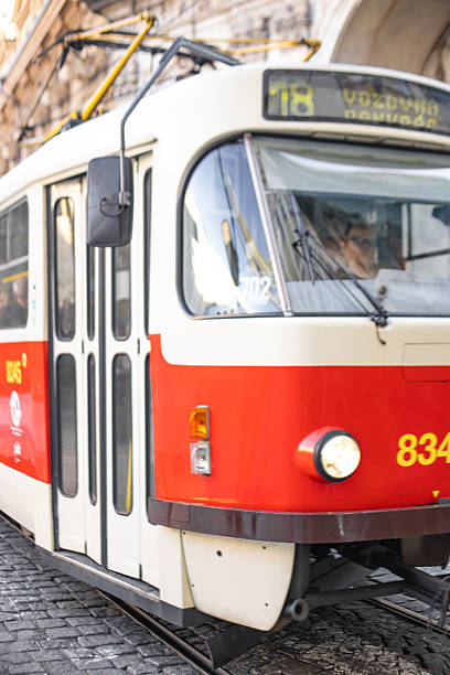 Prague, Czech republic - November 19, 2025: Classic red and cream tram moving along urban street. Public transport, daily commute, and travel in a historic city