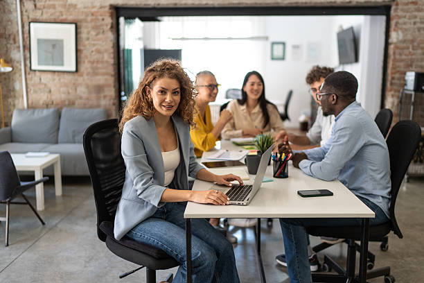 istock Young businesswoman using laptop in modern office meeting 2247965957