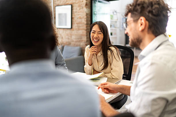 istock Diverse business team collaborating and laughing during office meeting 2247966510