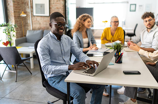 istock Smiling man collaborating with diverse business team in meeting 2247966609