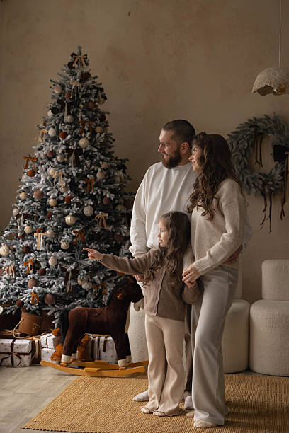 istock Family admiring a decorated Christmas tree at home 2247966614