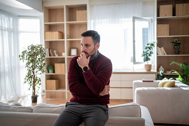 istock Worried man thinking about problems having anxiety at home 2247968069