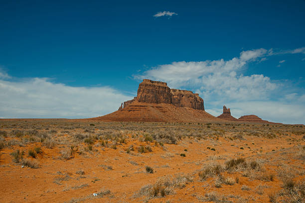 Sentinel Mesa stands guard in Monument Valley, a towering testament to the erosive forces of nature. The massive, flat-topped mountain rising over 6,400 feet above sea level. This tabletop mesa, detached from surrounding formations, dominates the landscape.