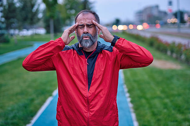 istock Mature adult man experiencing headache while training outdoors 2247983766