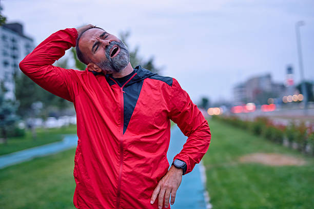 istock Man stretching neck experiencing discomfort after workout 2247983769