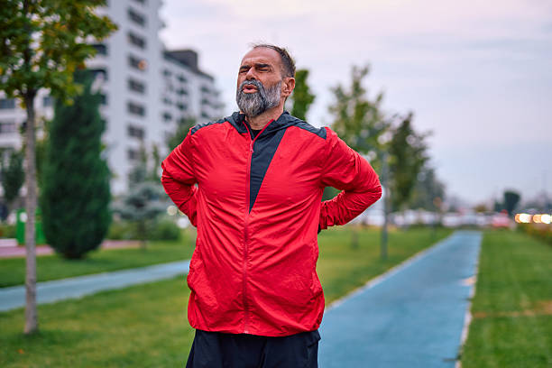 istock Senior man experiencing back pain while exercising outdoors 2247983776