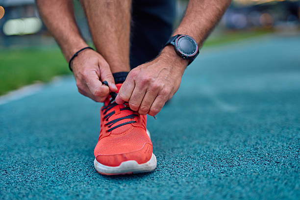 istock Man tying shoelace on running shoe before exercise 2247983836