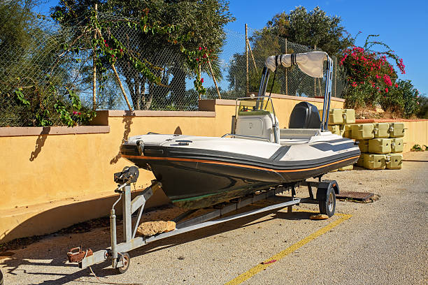 istock Road Trailer with Inflatable Motorboat by a Wall 2247984696