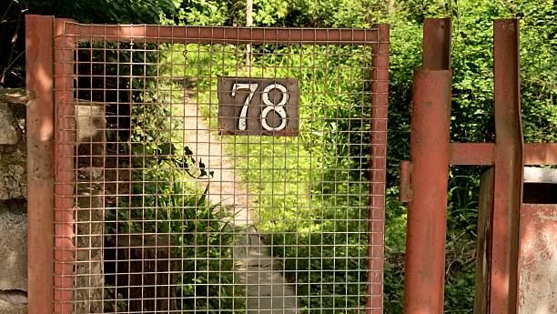 istock red rusted metal wire mesh gate featuring the number 78 plaque 2247985408