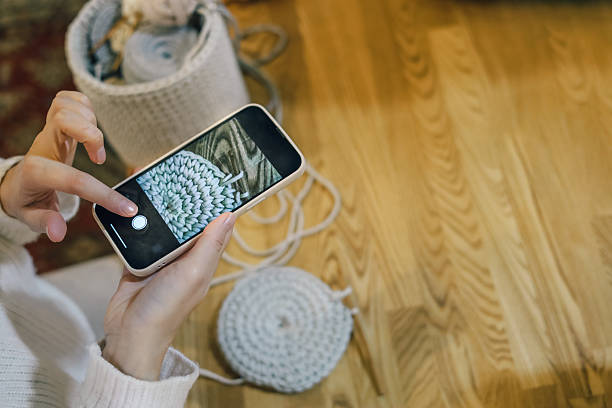 istock Woman photographing her crochet work with a smartphone during a creative crafting session 2247985591
